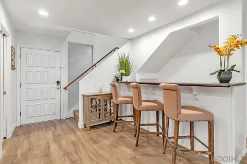 a view of entryway and hall with wooden floor