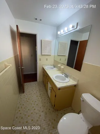 a bathroom with a sink a toilet a mirror and vanity