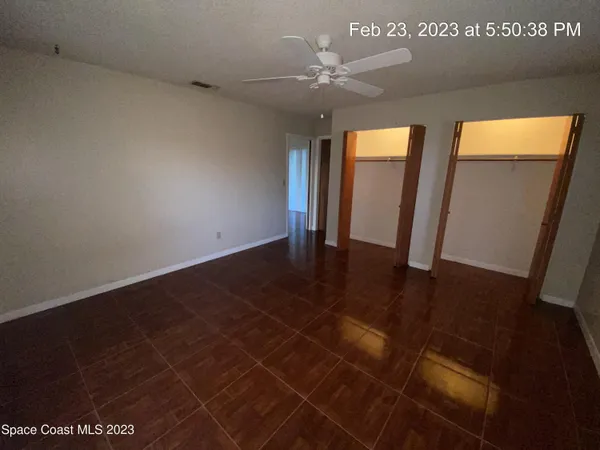 a view of an empty room with a mirror