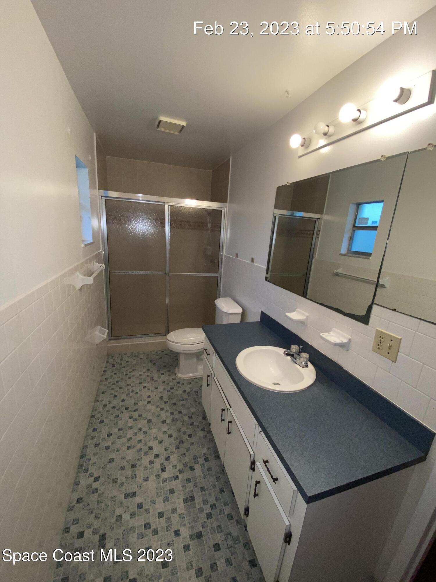304 Darrow Avenue Melbourne, FL 32901 - Photo 25 of 31 a bathroom with a sink and a mirror