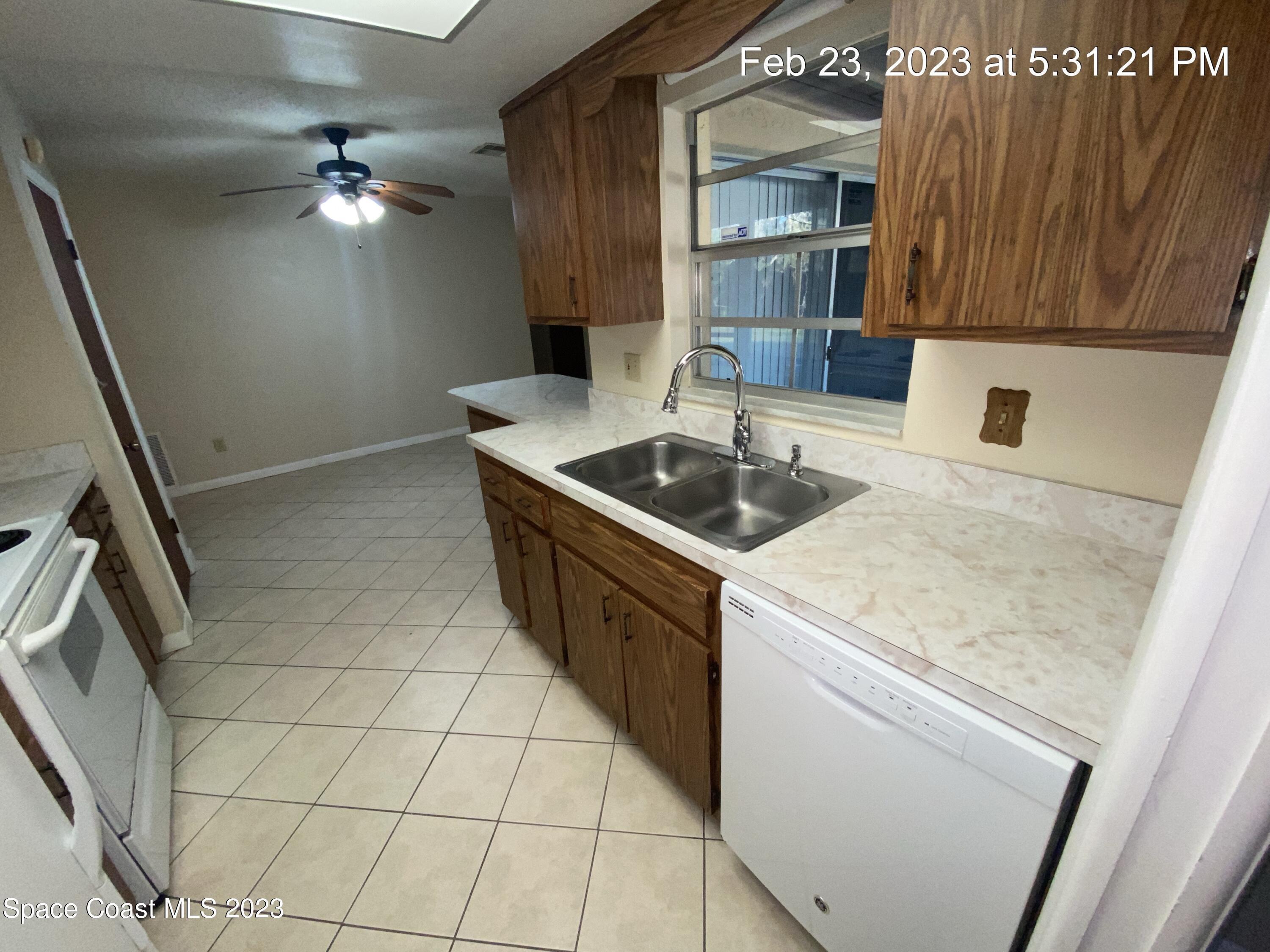 304 Darrow Avenue Melbourne, FL 32901 - Photo 5 of 31 a kitchen with a sink a stove oven and cabinetry