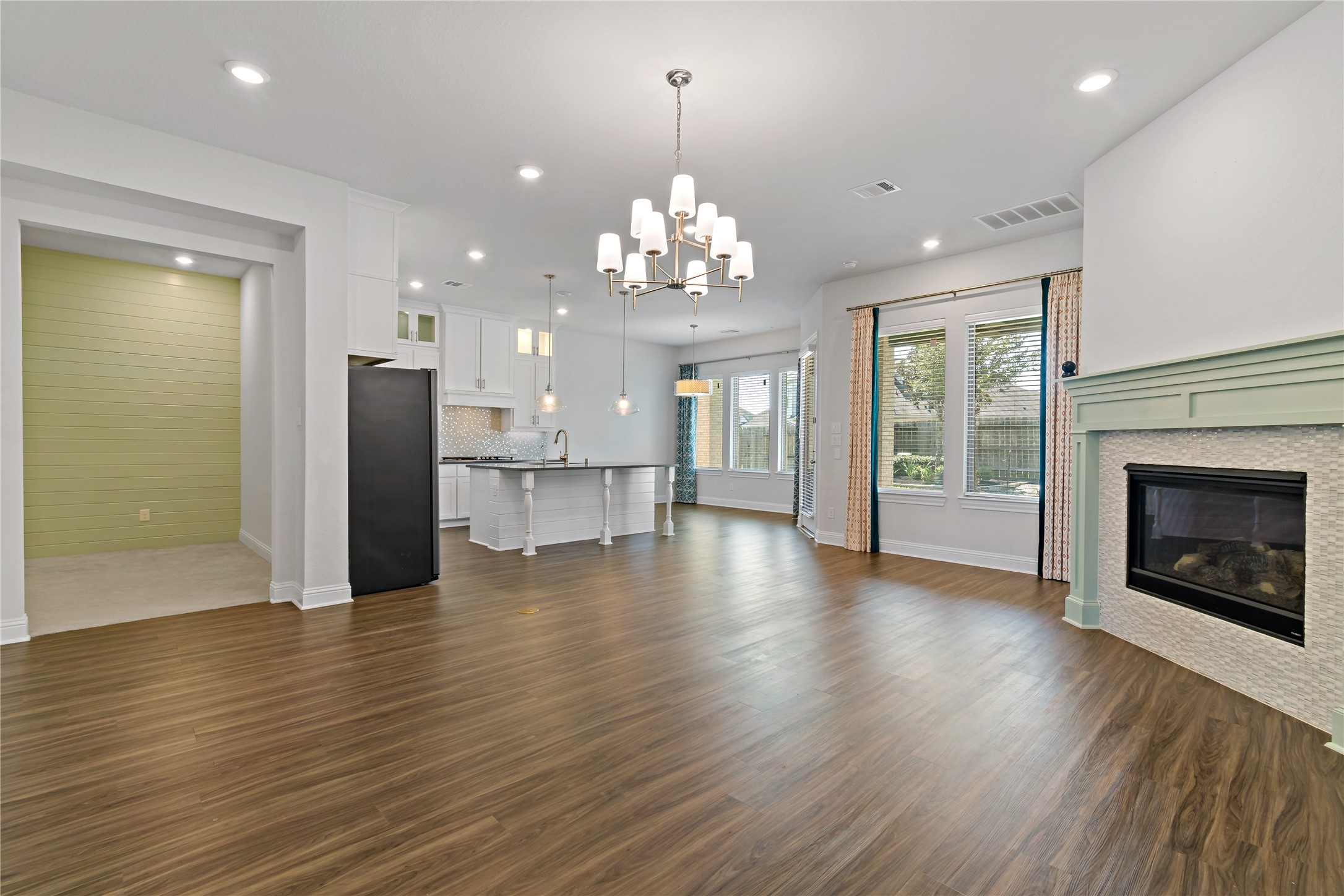 4802 Gingerwood Trace Lane Rosharon, TX 77583 - Photo 12 of 44 a view of a livingroom with a fireplace wooden floor and a kitchen