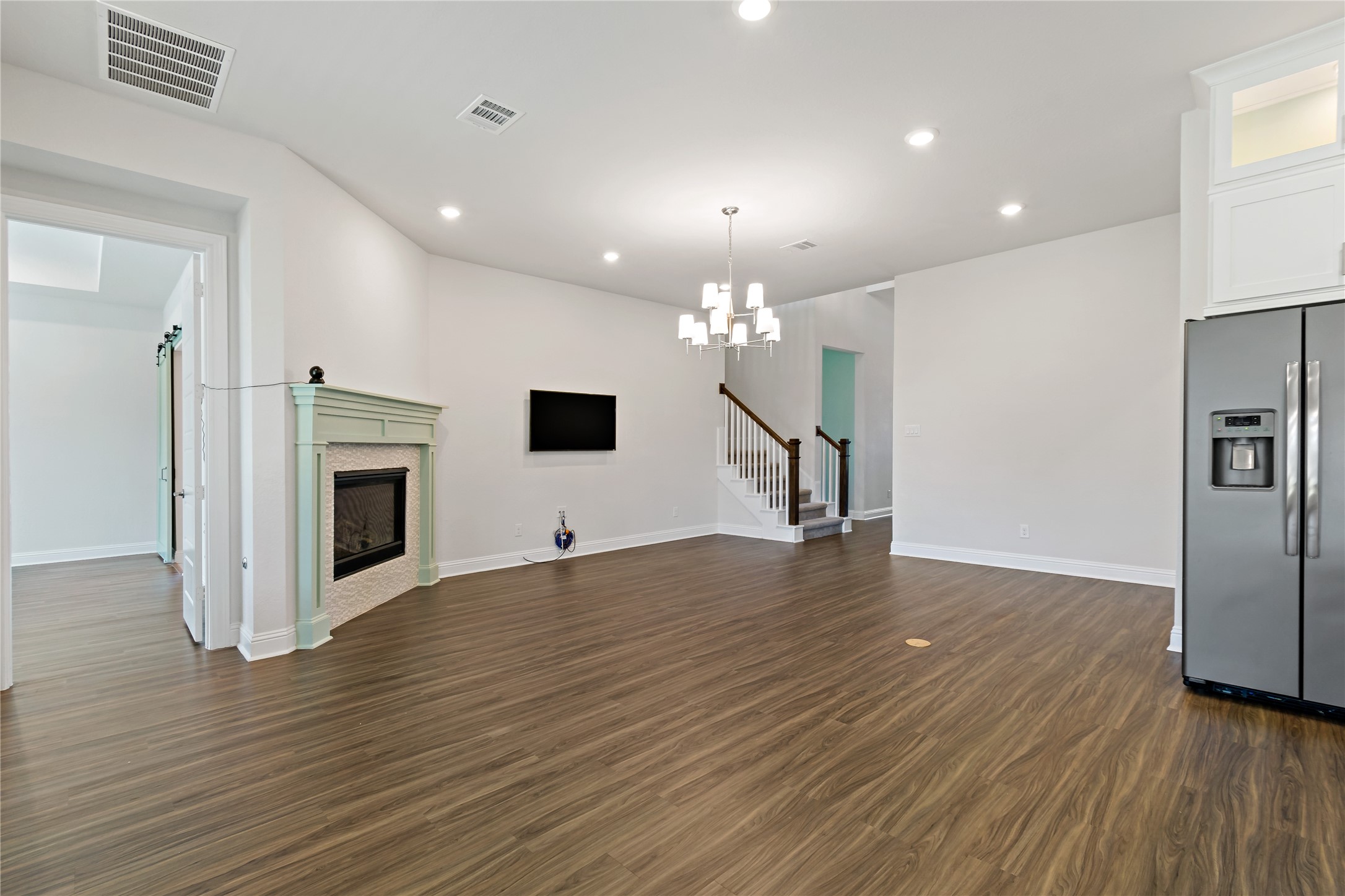 4802 Gingerwood Trace Lane Rosharon, TX 77583 - Photo 13 of 44 a view of a livingroom with wooden floor and a kitchen