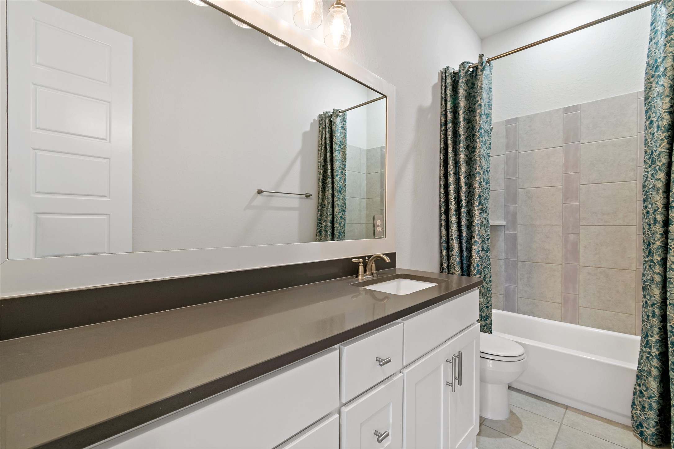 4802 Gingerwood Trace Lane Rosharon, TX 77583 - Photo 14 of 44 a bathroom with a granite countertop sink a toilet and a bathtub