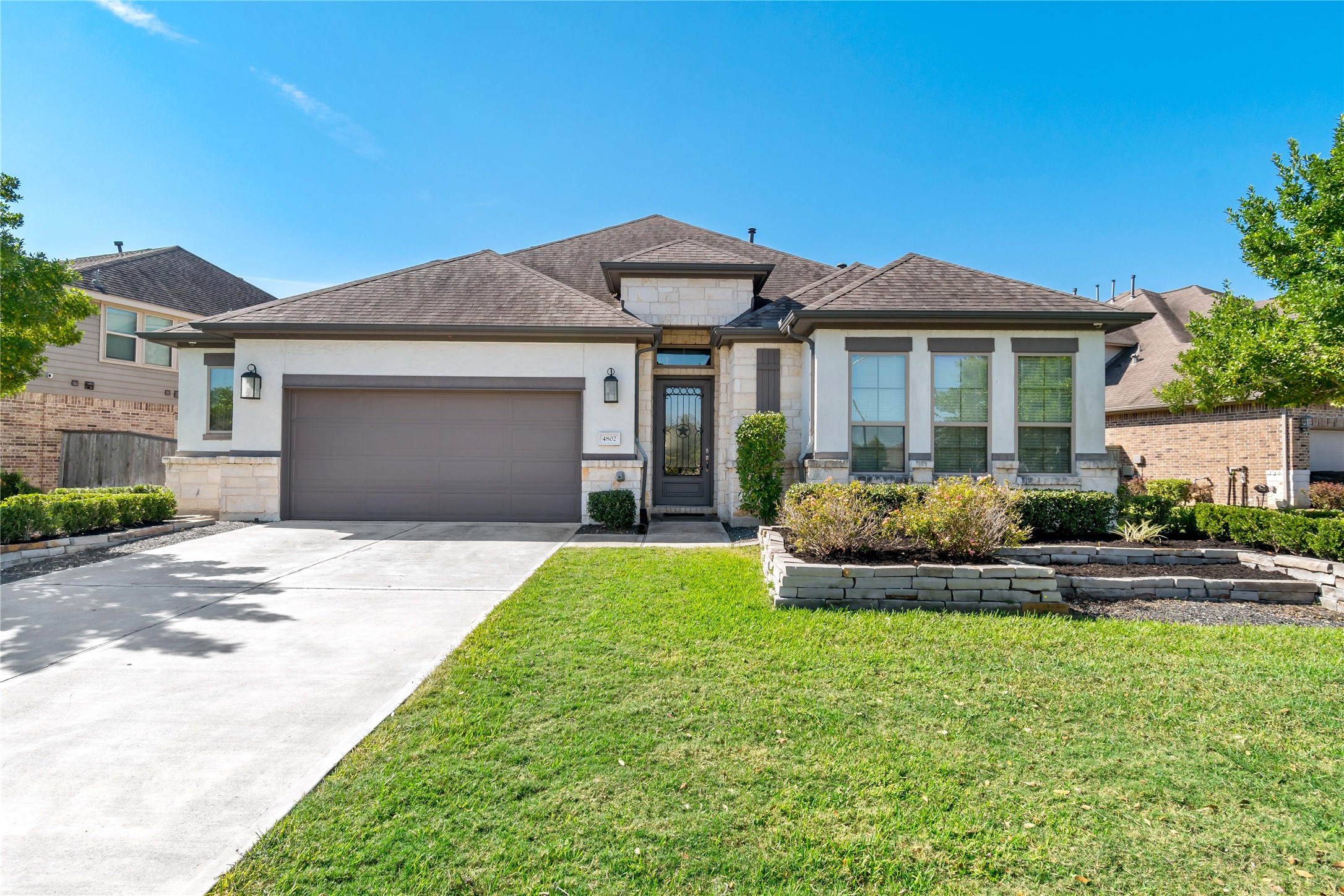 4802 Gingerwood Trace Lane Rosharon, TX 77583 - Photo 2 of 44 a front view of a house with a yard and garage
