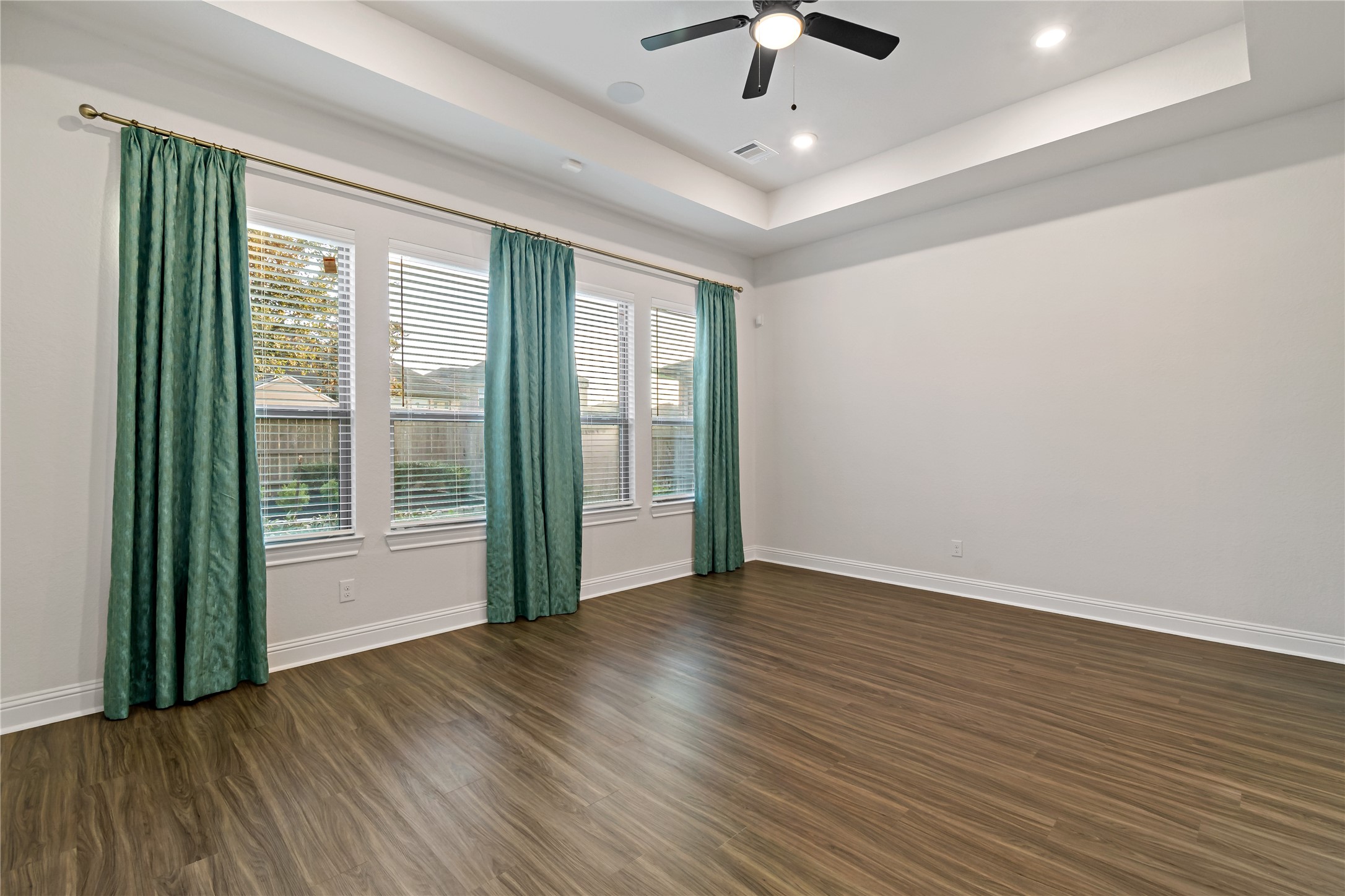 4802 Gingerwood Trace Lane Rosharon, TX 77583 - Photo 28 of 44 an empty room with wooden floor chandelier fan and windows