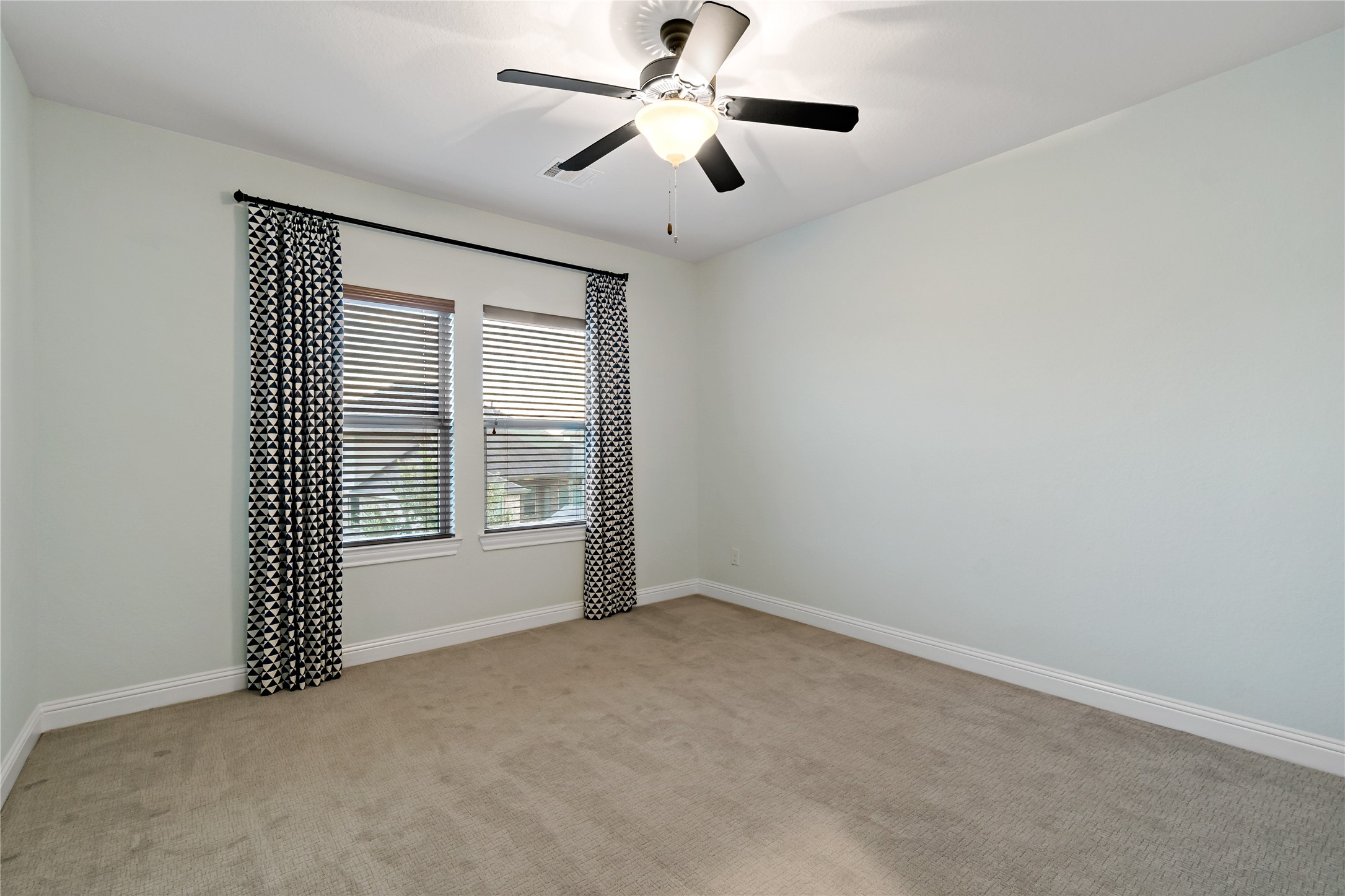 4802 Gingerwood Trace Lane Rosharon, TX 77583 - Photo 38 of 44 an empty room with ceiling fan and windows