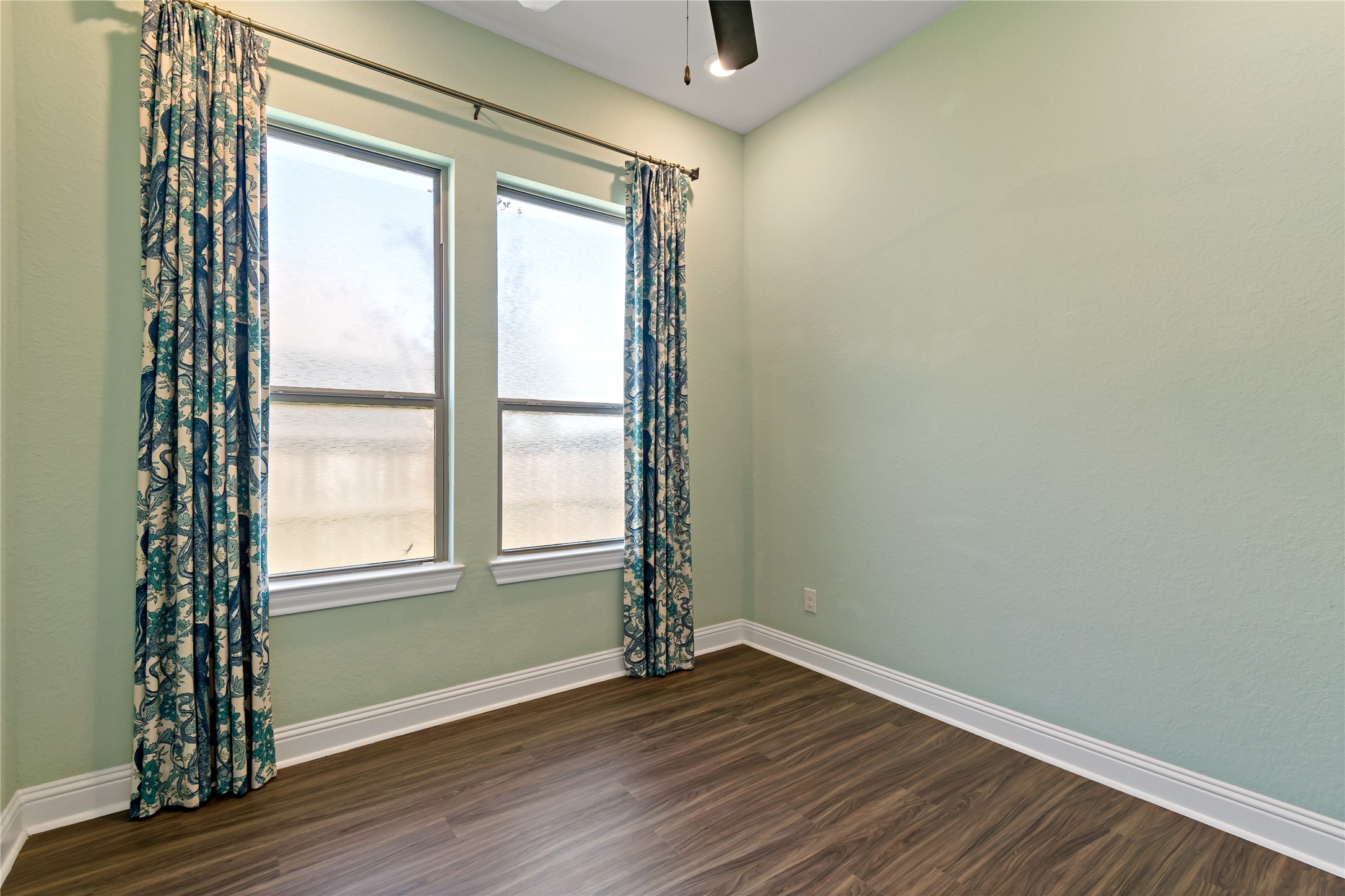 4802 Gingerwood Trace Lane Rosharon, TX 77583 - Photo 10 of 44 an empty room with wooden floor and windows