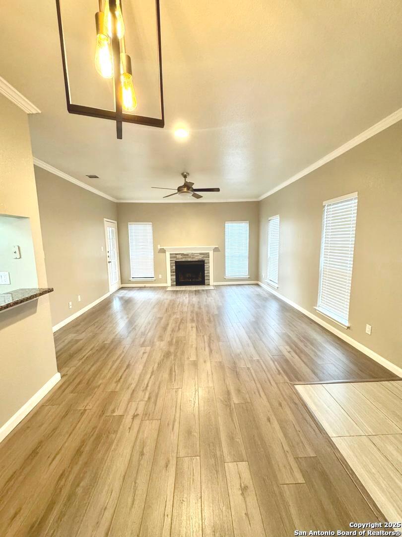 a view of empty room with wooden floor