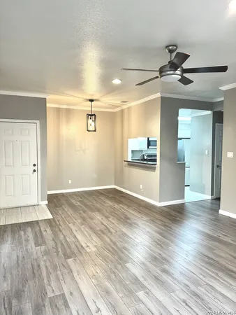 a view of a kitchen with wooden floor and a kitchen