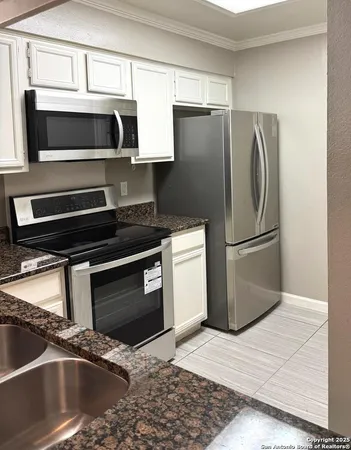 a kitchen with a refrigerator stove and microwave