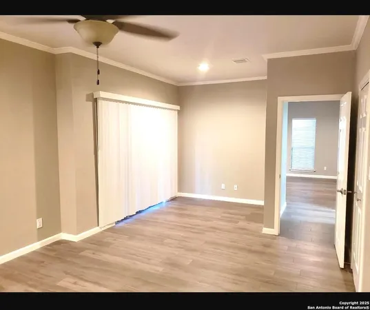 a view of a room with wooden floor