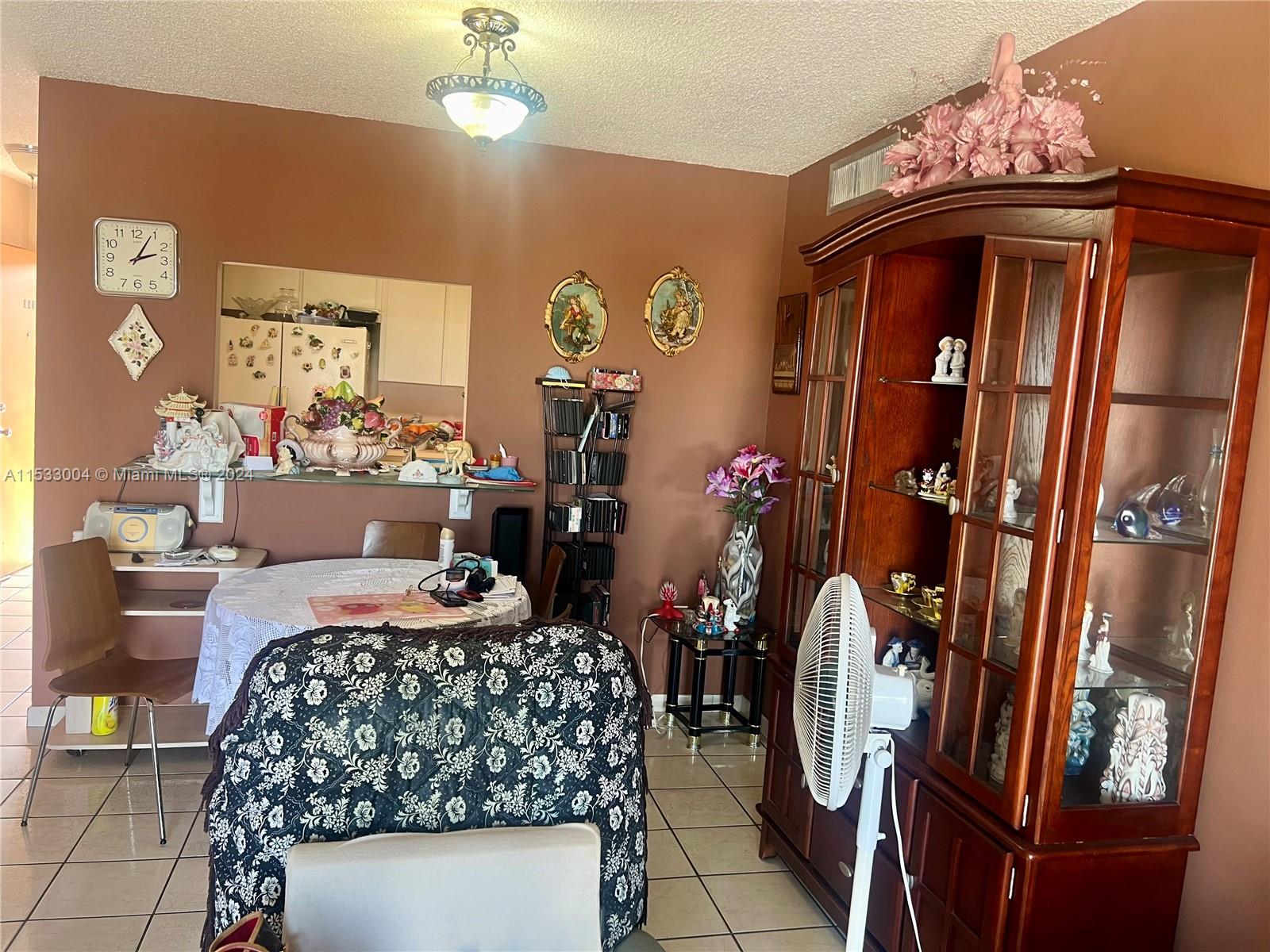 1075 West 68th Street, Unit 309 Hialeah, FL 33014 - Photo 15 of 21 a bedroom with furniture and a chandelier