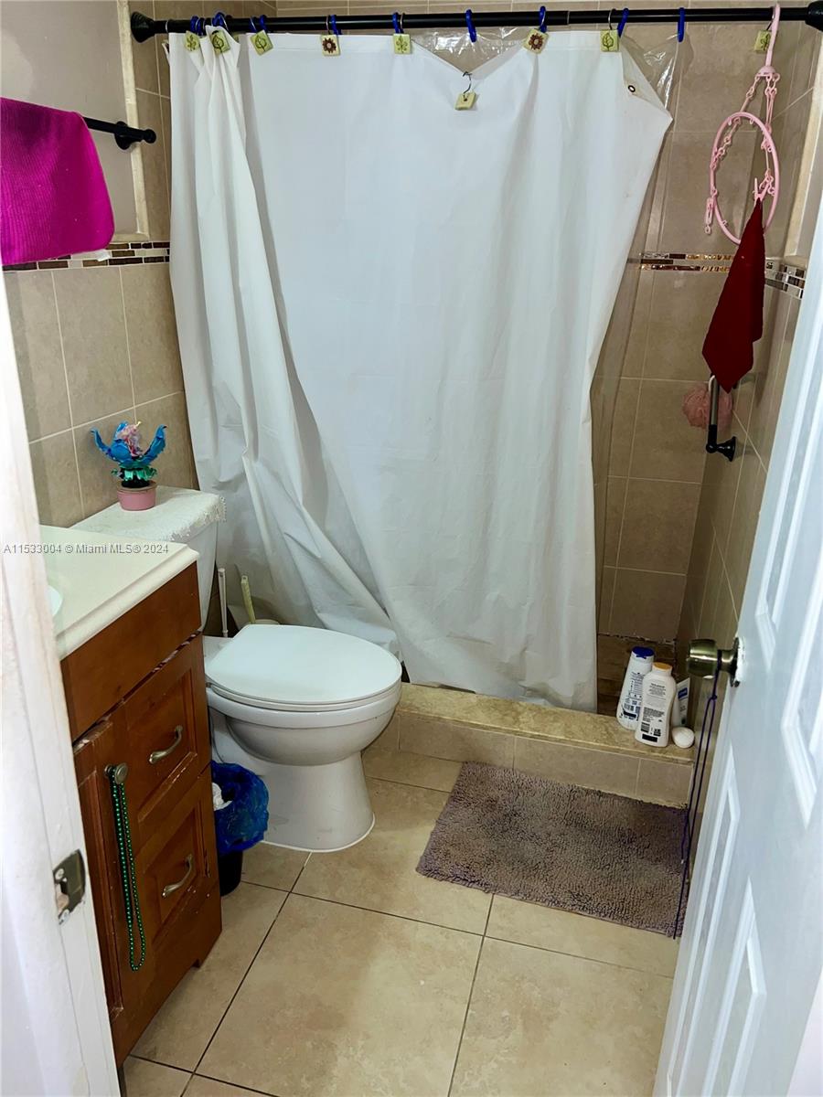 1075 West 68th Street, Unit 309 Hialeah, FL 33014 - Photo 17 of 21 a bathroom with a sink and toilet