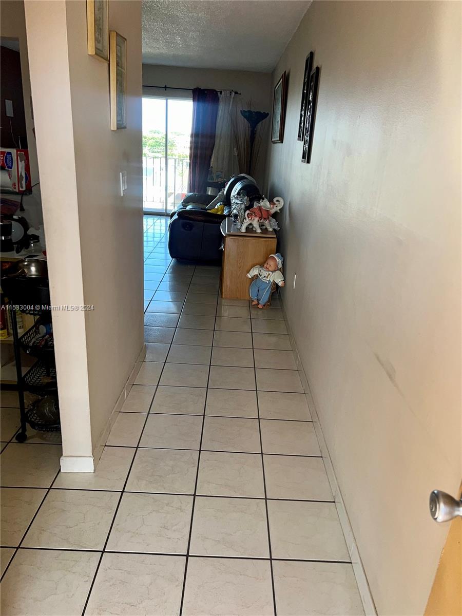 1075 West 68th Street, Unit 309 Hialeah, FL 33014 - Photo 3 of 21 a living room with furniture