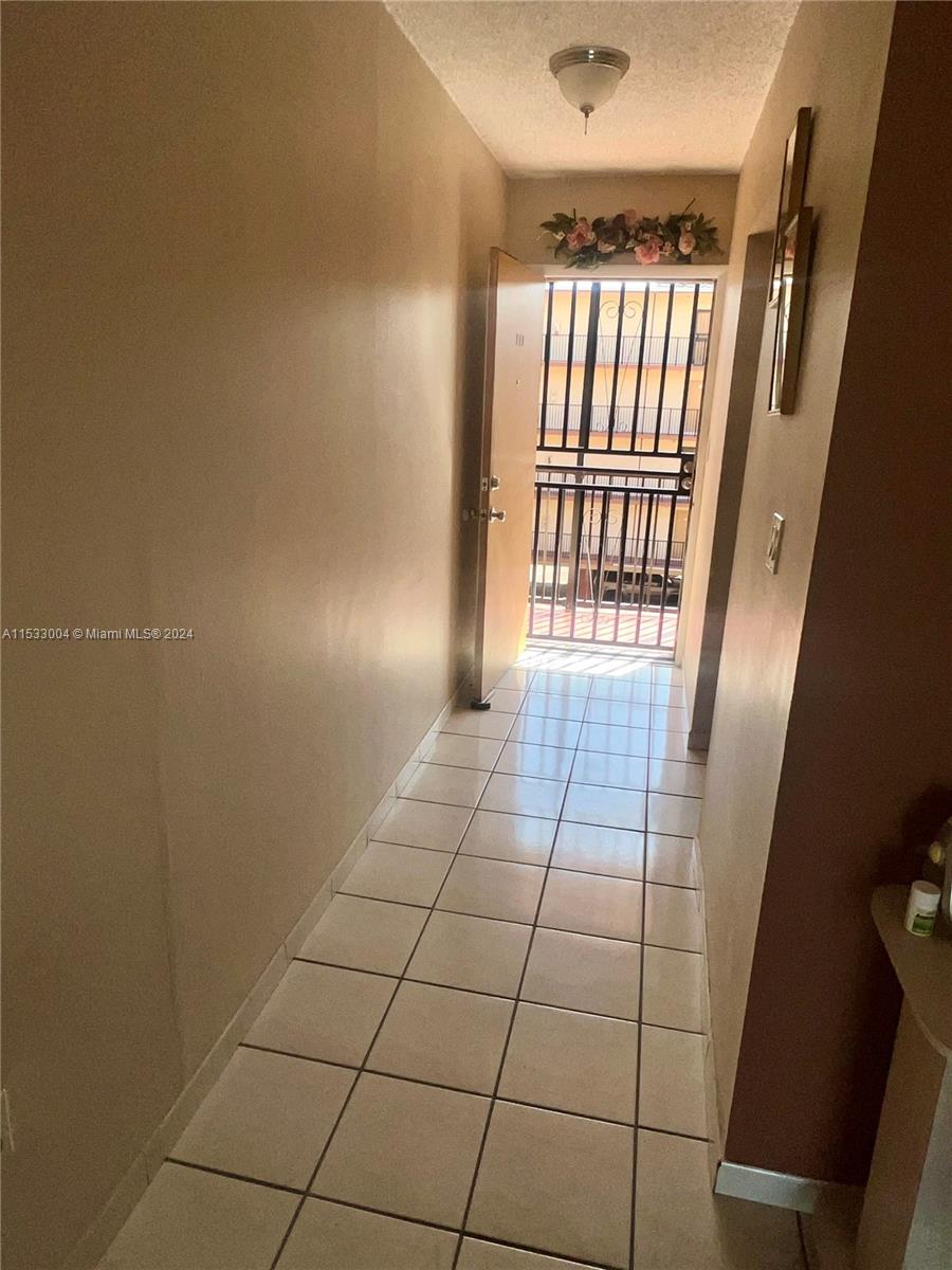 1075 West 68th Street, Unit 309 Hialeah, FL 33014 - Photo 4 of 21 a view of an empty room with a window