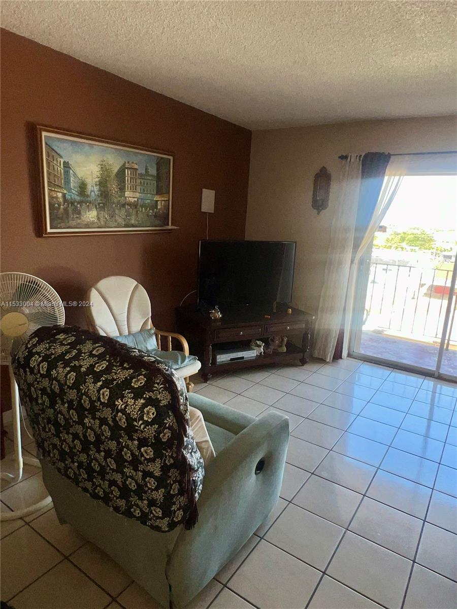 1075 West 68th Street, Unit 309 Hialeah, FL 33014 - Photo 8 of 21 a bedroom with a bed dresser and window