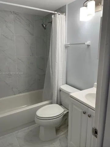 a bathroom with a toilet and a bath tub