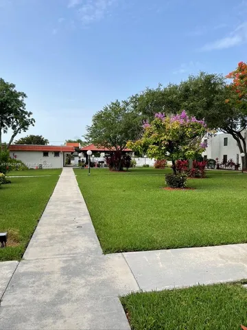 a view of a garden with houses