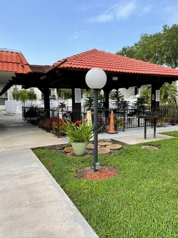 a view of a house with garden and sitting area