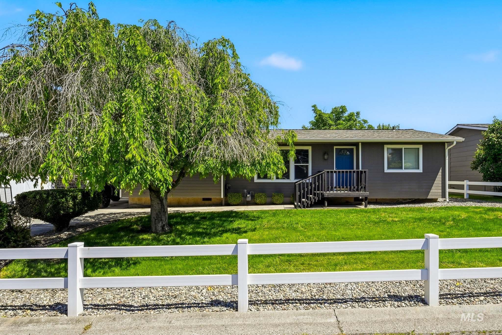 3715 18th Street Lewiston, ID 83501 - Photo 30 of 30 Single-story residence featuring a dark gray exterior, white trim windows, and a blue entry door