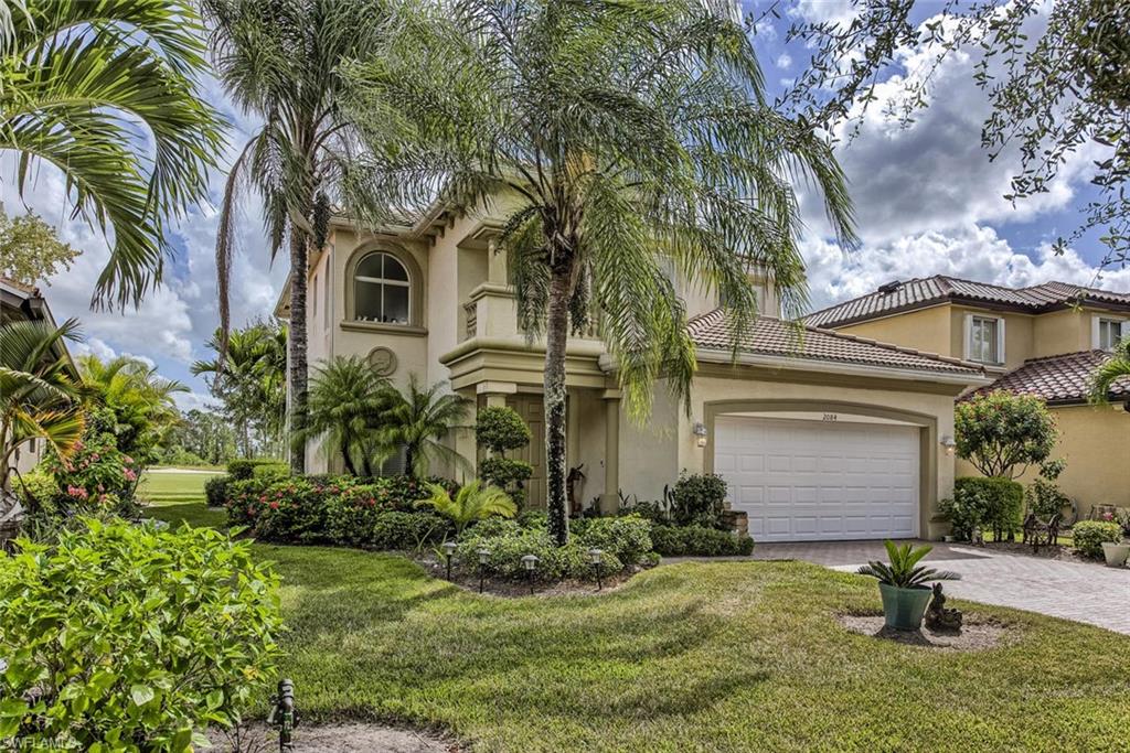 2084 Par Drive Naples, FL 34120 - Photo 1 of 29 a front view of a house with garden