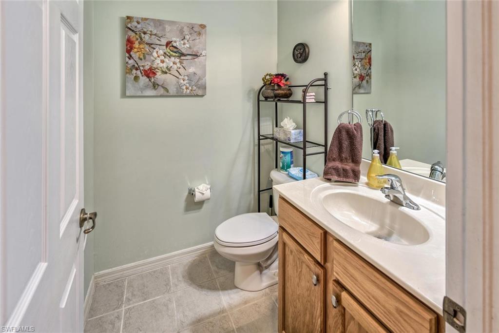 2084 Par Drive Naples, FL 34120 - Photo 15 of 29 a bathroom with a toilet sink and mirror
