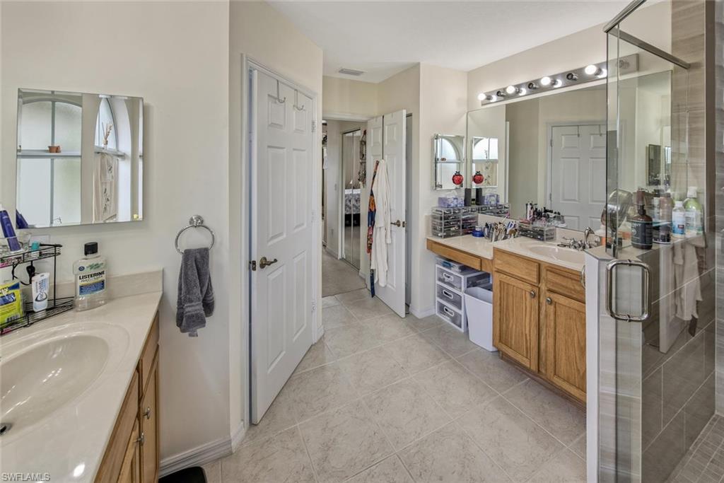 2084 Par Drive Naples, FL 34120 - Photo 20 of 29 a bathroom with a granite countertop sink a washer and dryer