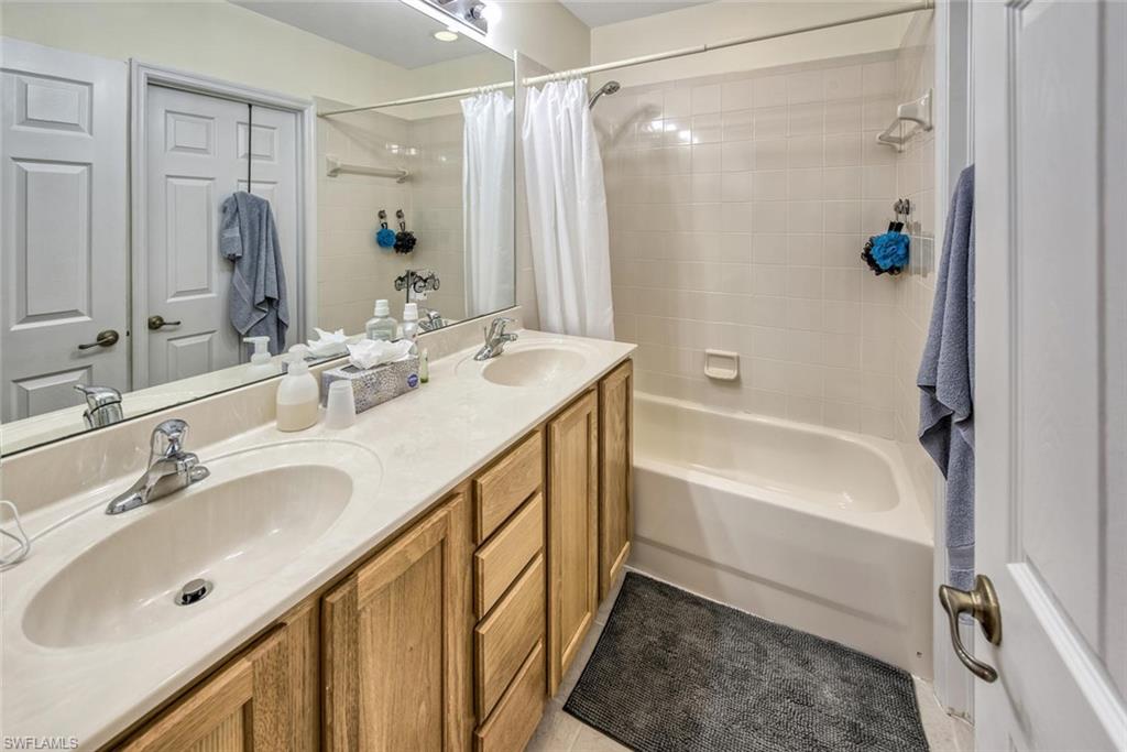 2084 Par Drive Naples, FL 34120 - Photo 21 of 29 a bathroom with a tub sink shower and mirror