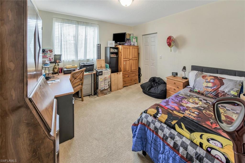 2084 Par Drive Naples, FL 34120 - Photo 22 of 29 a bedroom with furniture and a window
