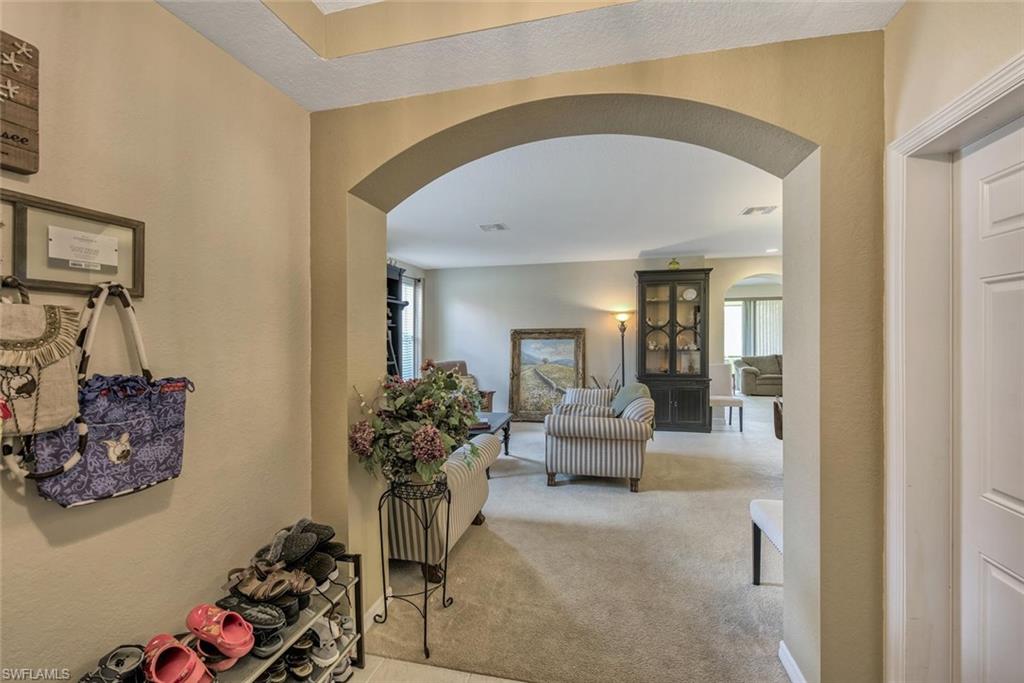 2084 Par Drive Naples, FL 34120 - Photo 6 of 29 a living room with furniture and flowers