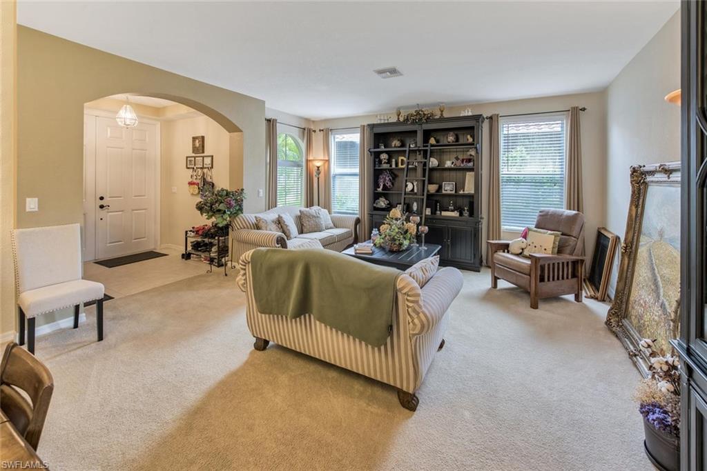 2084 Par Drive Naples, FL 34120 - Photo 8 of 29 a living room with furniture and a flat screen tv