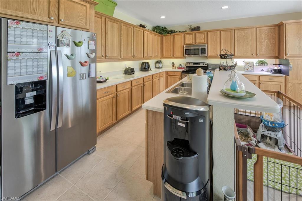 2084 Par Drive Naples, FL 34120 - Photo 10 of 29 a kitchen with stainless steel appliances granite countertop a refrigerator a stove and a cabinets