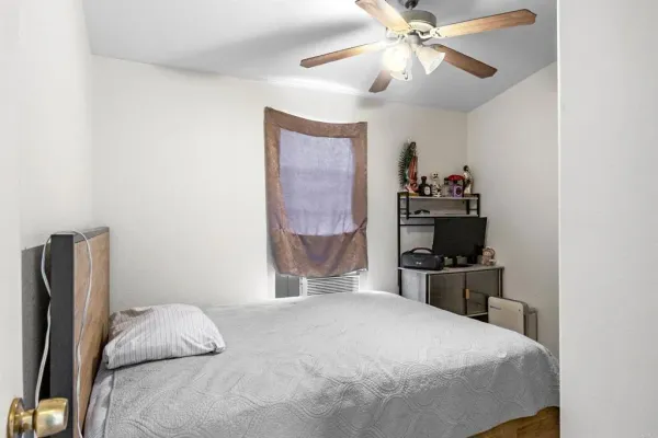 a bedroom with a bed and a chandelier
