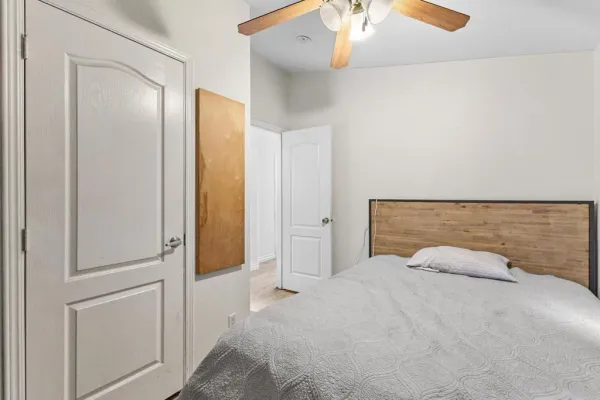 a bedroom with a bed and a chandelier