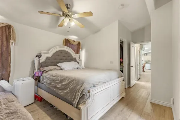 a bedroom with a bed and a chandelier