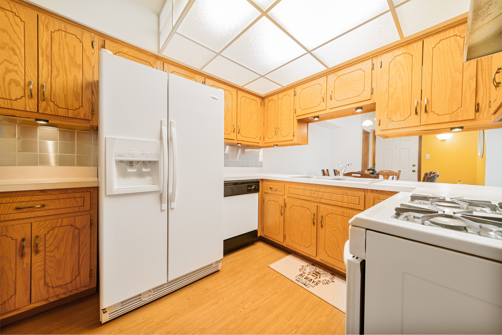 10640 Ridgeland Avenue, Unit 1C Chicago Ridge, IL 60415 - Photo 8 of 16 a kitchen with cabinets appliances and a wooden floor