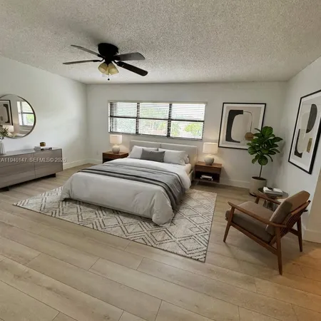 a living room with furniture a chandelier a rug and a window