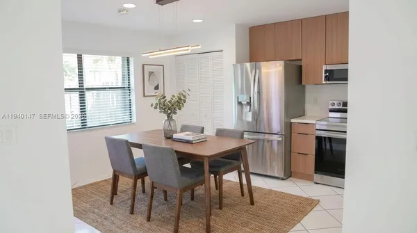 a living room with furniture potted plant and a lamp