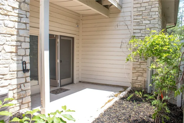 a view of door and wooden bench
