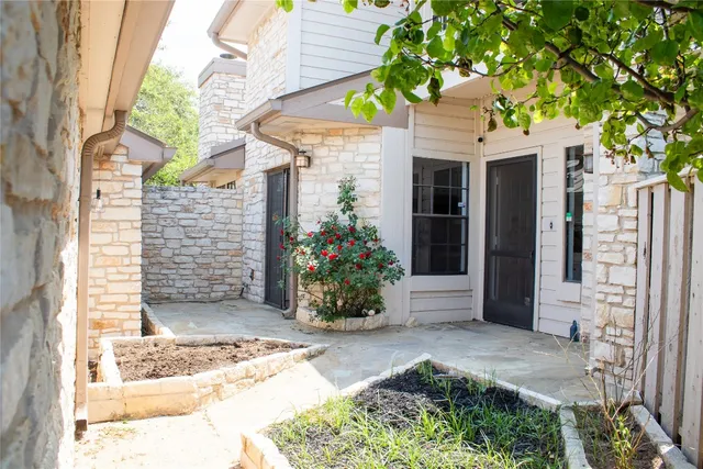 a view of a house with potted plants