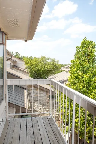 a view of a balcony with wooden floor