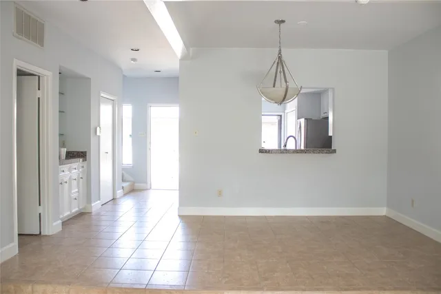 a hallway with closet and a chandelier