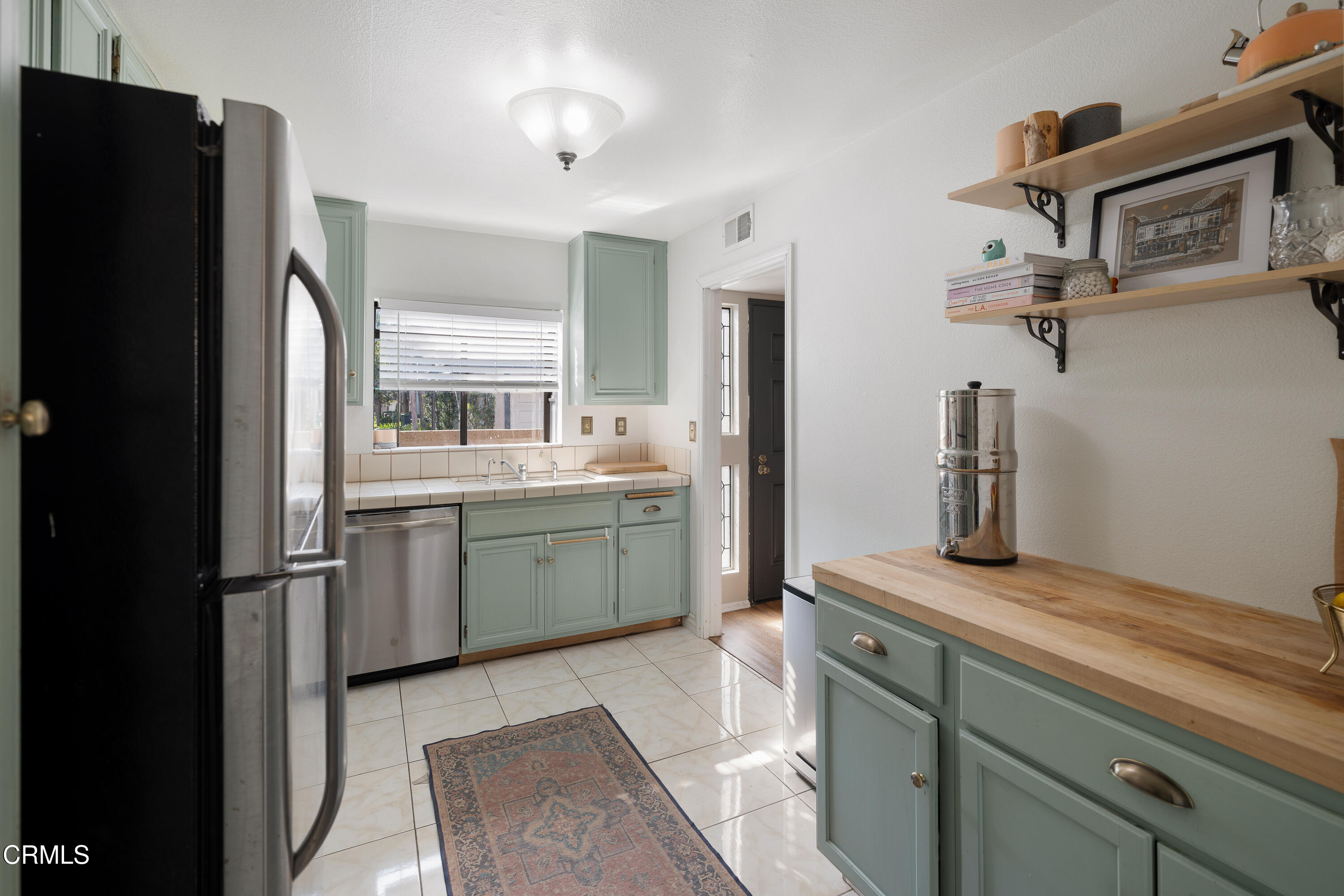 896 Swiss Trails Road Duarte, CA 91010 - Photo 11 of 33 a kitchen with a refrigerator and cabinets