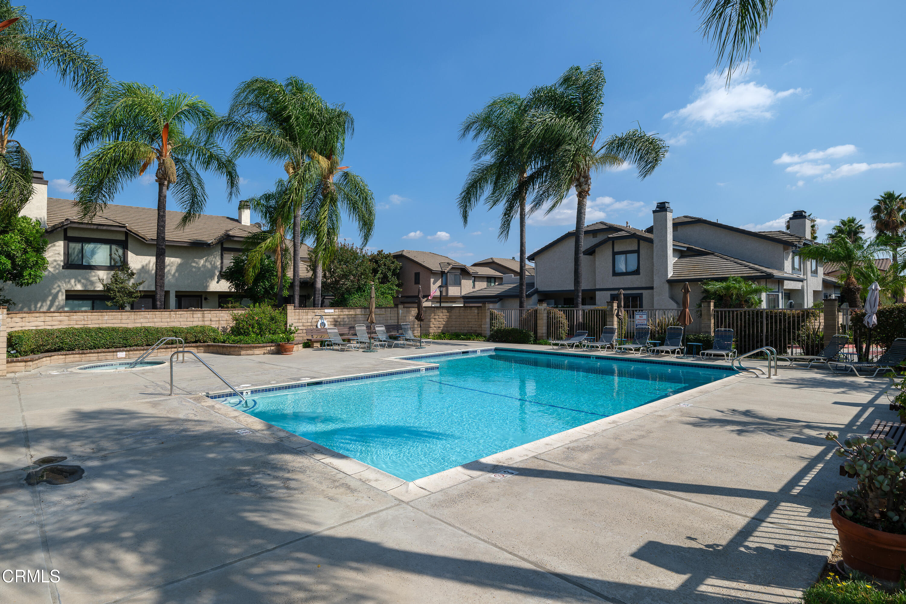 896 Swiss Trails Road Duarte, CA 91010 - Photo 30 of 33 a view of a swimming pool with a lawn chairs under palm trees