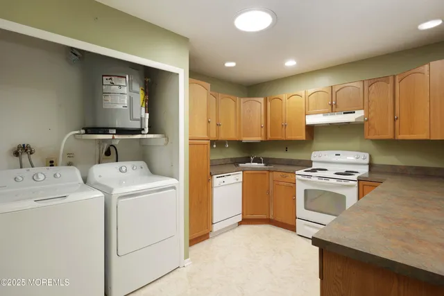 a kitchen with a stove sink and cabinets