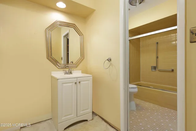 a bathroom with a granite countertop mirror and a sink