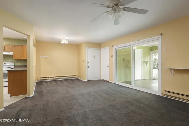 an empty room with fan and entrance