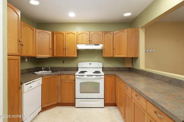 a kitchen with a stove top oven sink and cabinets