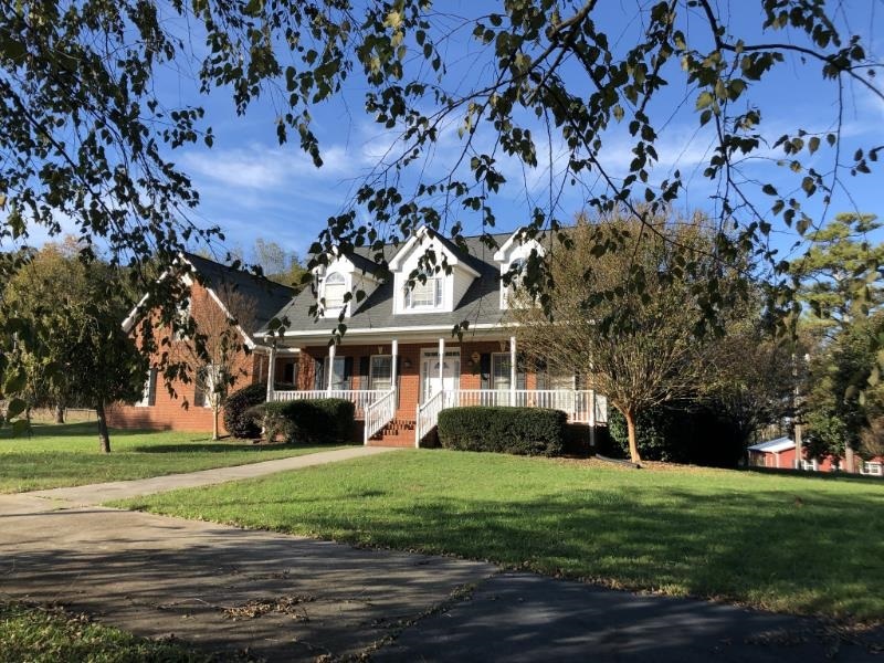 1370 Snows Mill Road Monroe, GA 30655 - Photo 1 of 1 a front view of a house with a garden